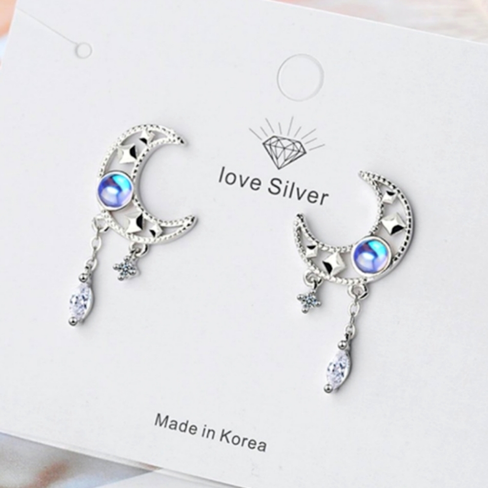 Sterling silver earrings of the moon and the stars with a blue simulated diamond